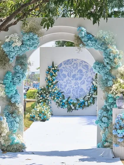 Inspired by the French Riviera, this entrance arch combines powder blue and white hydrangeas for a breezy, European chic aesthetic. It’s a perfect example of how I can create a sophisticated and whimsical atmosphere for a daytime carnival or welcome lunch.
