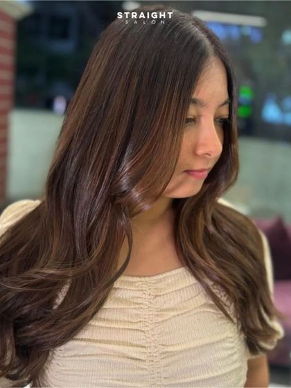 A happy client with her freshly colored and styled hair.