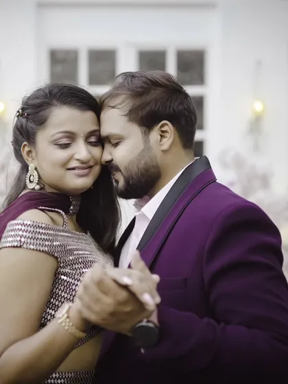 A slow dance, a quiet moment. This close-up captures the couple lost in their own world, their elegant outfits and the soft focus creating a deeply romantic and intimate feel.