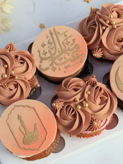 A box of six Eid cupcakes with custom toppers, including Arabic calligraphy and even a guitar for a personalized touch. This shows how I can tailor my creations to your specific gifting needs.