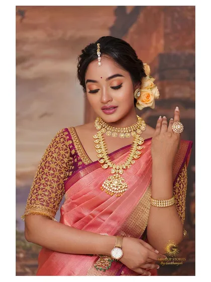 Actress Sowmya John in a beautiful peach Kanchivaram saree. I designed the contrasting maroon blouse with intricate gold jaal embroidery on the sleeves.