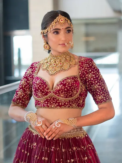 This shot highlights the stunning details of the bridal blouse and jewellery. The makeup is kept classic and clean to ensure the focus remains on the overall traditional elegance.
