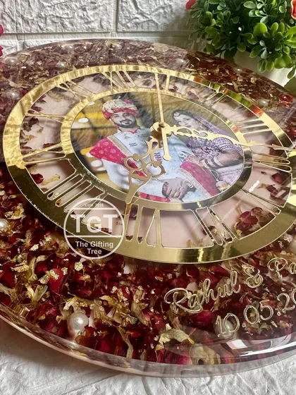 A close-up angle of the clock, focusing on the custom golden text with the couple's names and wedding date at the bottom.