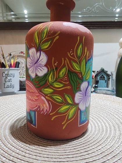 The back of the terracotta bottle from our workshop, showing how the artist continued the beautiful floral theme all the way around.