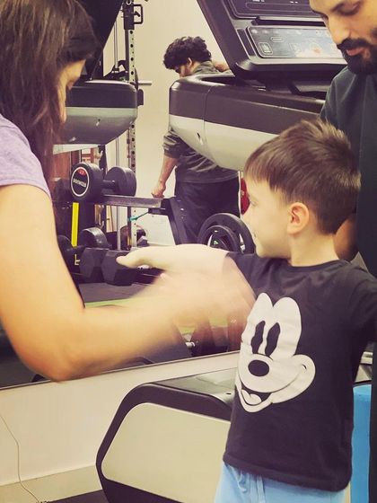 A therapist interacts with a young client during a balance exercise. Building trust and rapport is essential in pediatric physiotherapy to achieve the best outcomes.