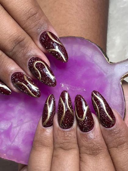 Another view of the disco glitter and line art nails. The combination of the sparkling red base and the smooth gold lines creates a beautiful textural contrast.