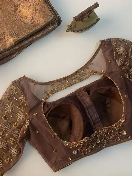 This blouse was designed for a brocade saree. I used a sheer brown fabric with antique gold embroidery to create a sophisticated and understated look.