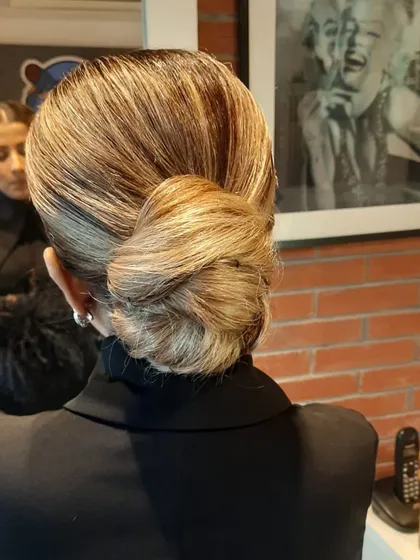 A flawlessly executed low bun, showcasing our expertise in creating sleek and elegant hairstyles. This classic updo is perfect for any formal occasion, keeping the look neat while highlighting the client's features.