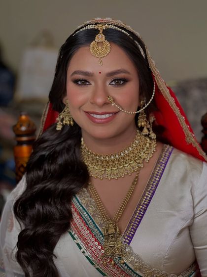 A stunning close up of this bride's Pheras look. We paired her white and gold outfit with a classic smokey eye and a warm nude lip for a timeless and elegant feel.