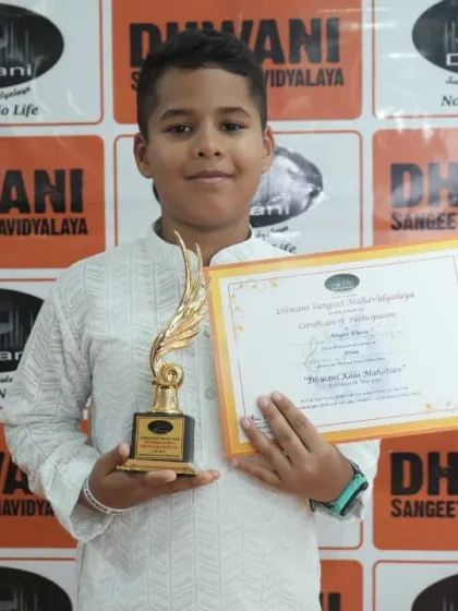 A young student proudly displays his certificate and award. We encourage discipline and dedication from an early age, building a foundation for lifelong health and wellness.