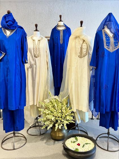 A beautiful display of royal blue and ivory kurta sets, showcasing classic silhouettes with rich gold and silver embroidery.