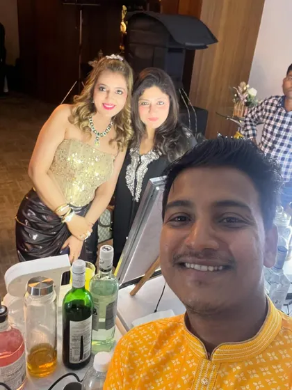 Posing with guests at the bar. We create a friendly, approachable atmosphere where guests feel comfortable asking for their favorite drinks.