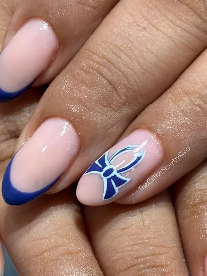 This nail features a classic blue French tip with a detailed, hand-painted bow accent, showcasing my fine line work.