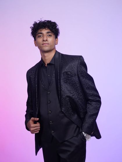 A full-length view of our classic black tuxedo. The jacquard print on the jacket adds a touch of texture and sophistication.