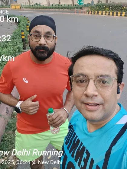 Two members after a 10km run, with their stats displayed. We encourage each other to hit new personal bests.