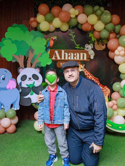 A guest poses with the birthday boy. The joy and community spirit are palpable at our celebrations.