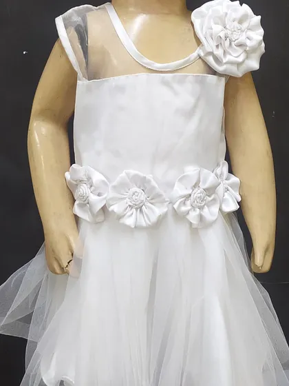 The skills learned in our courses have direct, real-world applications. This elegant children's party frock, complete with handmade satin flowers, was designed and constructed by a student, showcasing their proficiency in garment making and decorative detailing.