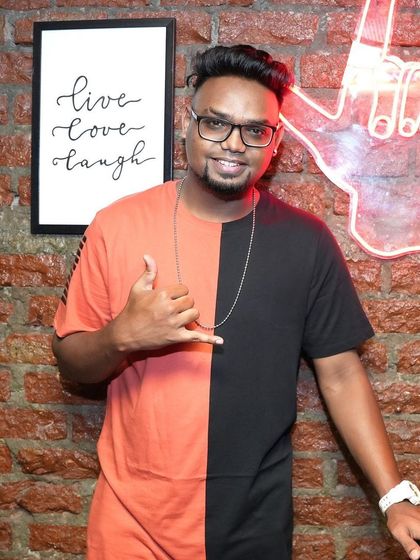 Posing for a quick photo at one of my gigs. The venue's atmosphere is important, and I always match my energy to the space, whether it's a relaxed lounge or a high-energy nightclub.