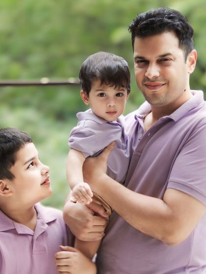 A sweet moment of connection as the older brother looks up at his baby brother. Capturing these fleeting glances is what makes sibling photography so special.