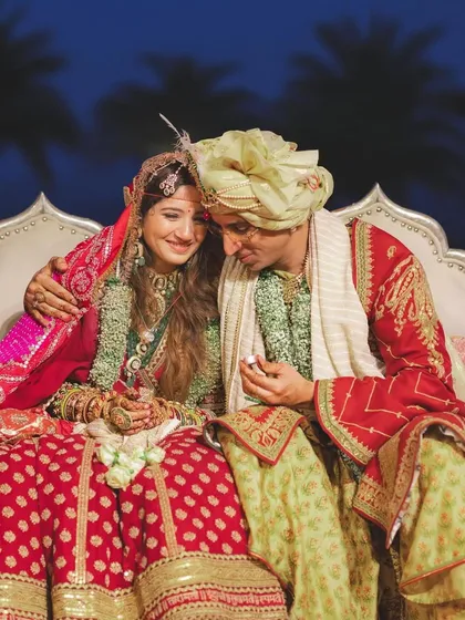 A quiet, candid moment of the couple during their wedding ceremony, their hands intertwined, ready to start their forever.