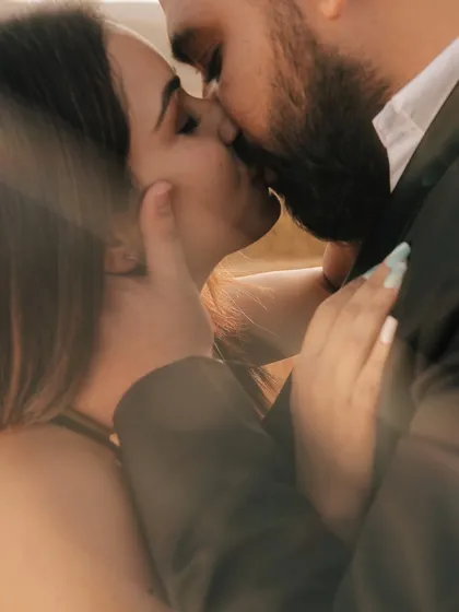 An intimate and passionate close-up of a kiss, capturing the deep connection and emotion between the couple.