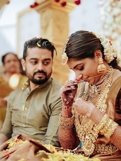 A quiet moment during Sradha and Vinay's wedding ceremony. The groom's loving gaze and the bride's gentle focus create a deeply emotional scene.