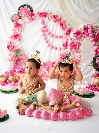One little Krishna adjusting his crown while the other looks on. Capturing these candid moments between two babies is always fun.