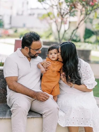 A mother gives her son a sweet kiss on the cheek. These simple, loving gestures create the most heartfelt family portraits.