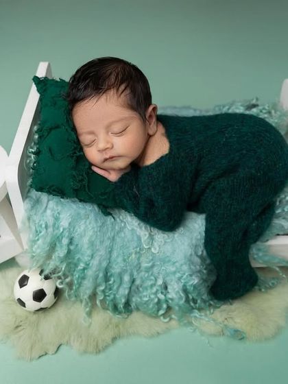A slightly different composition of the little sports fan, sleeping soundly in a miniature bed. The details, like the tiny sunglasses, add a touch of fun to the setup.