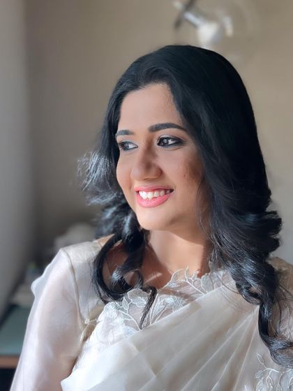 The sunlight catches her glowing skin, showing how natural makeup can be radiant and beautiful.