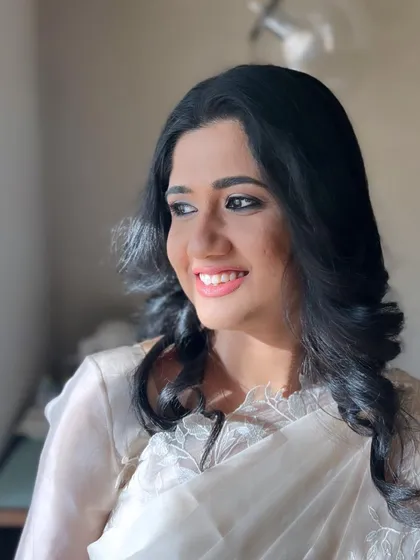 The sunlight catches her glowing skin, showing how natural makeup can be radiant and beautiful.
