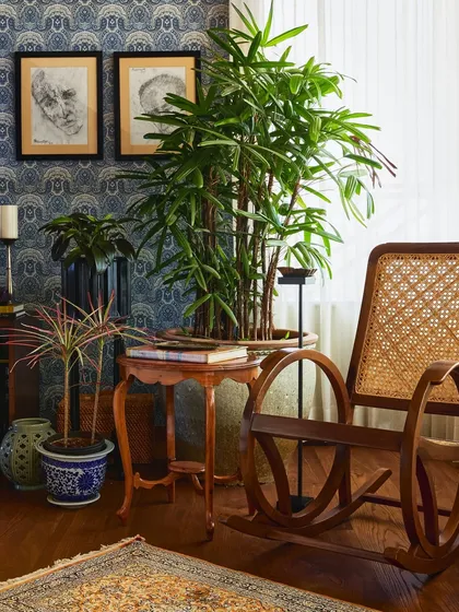 This cozy reading nook was built around a single cherished piece: the client's grandfather's rocking chair. By layering it with varied planters, a vintage table from Chor Bazaar, and bold paisley wallpaper, we created a corner that feels both nostalgic and fresh, proving that sentimental items can be the heart of a modern space.
