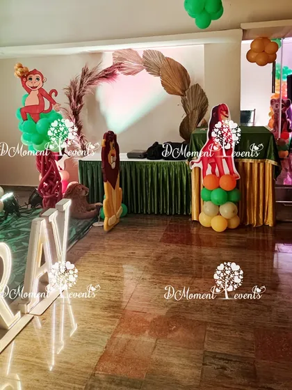 The main party area for the Lion King theme, featuring character cutouts, marquee letters, and a boho-style dried leaf arch.