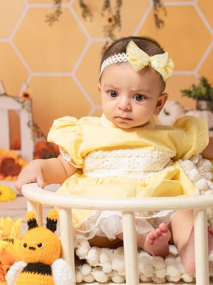 A sweet newborn sleeping in a basket as part of our sunflower and bee theme, showing how I can incorporate themes even for the tiniest clients.