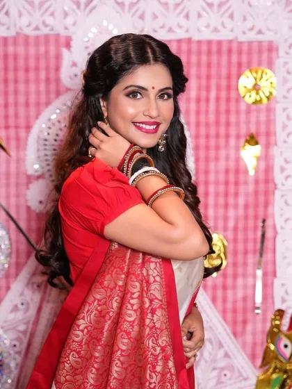 A happy and radiant shot of the Bengali look, showing how the makeup enhances the client's natural smile and features.