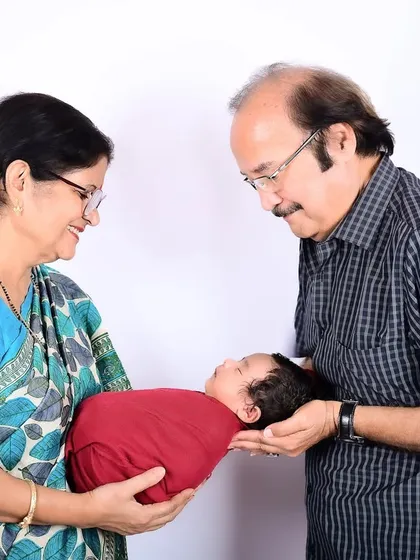 There's a special kind of magic when grandparents hold their grandchild for the first time. This multi-generational portrait captures that priceless, heartwarming bond that your family will cherish for generations to come.
