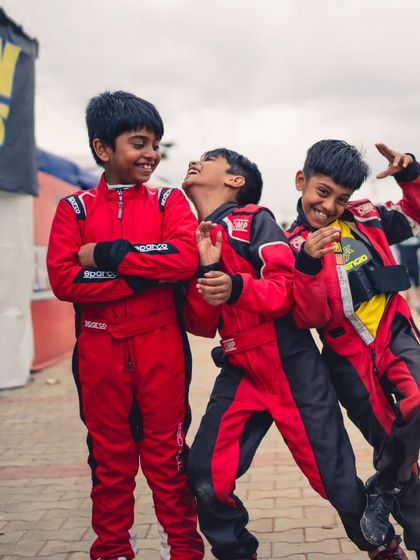 The future of our team. Our youngest micro-max drivers sharing a laugh in the pits. We foster a fun and supportive atmosphere where friendships are built alongside racing skills.