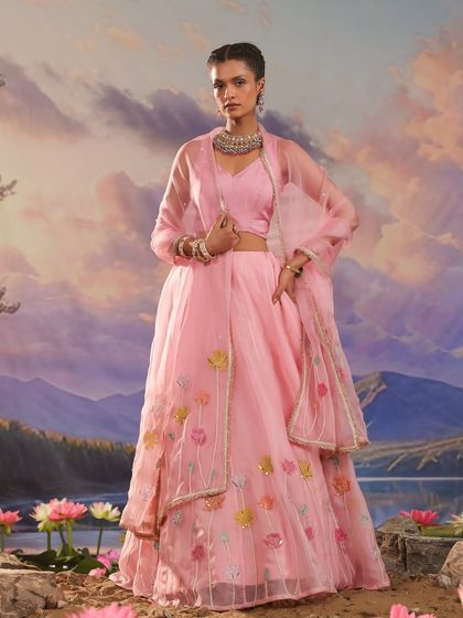 A stunning pink lehenga from the Gulnaar collection, featuring delicate floral embroidery on the sheer overlay.