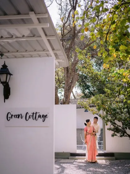 A couple poses outside one of the 'Green Cottages' at Backyard. These private, air-conditioned rooms are perfect for getting ready or taking a quiet moment during your event.