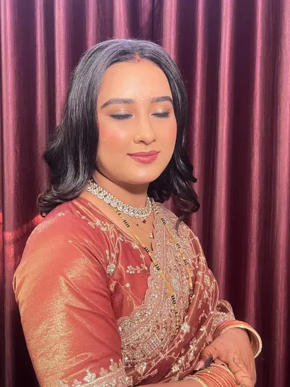 A close-up of this elegant reception look. The soft smokey eye and nude lip are a classic combination that never goes out of style.
