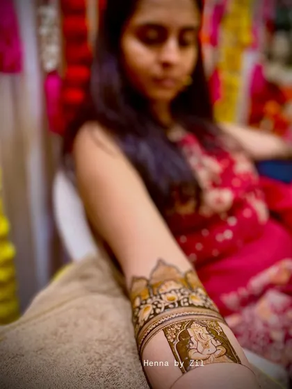 A close-up shot of me applying a Ganesha motif. Every stroke is made with focus and love.