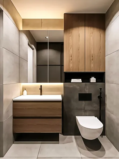 A minimalist bathroom design with large grey tiles and wood-toned cabinetry. The backlit mirror and simple, clean lines create a serene and modern space.