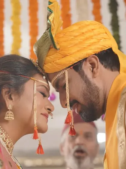 A close-up shot of the couple's foreheads touching, a symbolic and emotional moment from their Maharashtrian wedding ceremony.