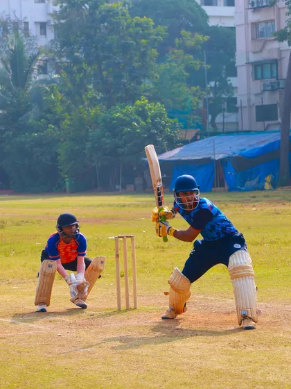 A batsman facing a bowler in our practice match, a classic duel between bat and ball.