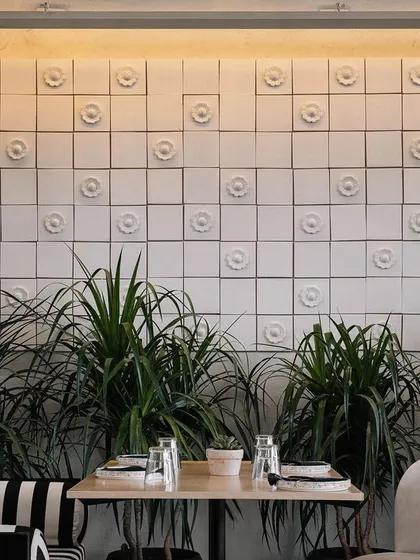 A feature wall at Brassa showcases handmade terracotta tiles from the Kumbhar potters of Kutch. We collaborated with the artisans to create this custom relief pattern, turning a simple wall into a testament to local craftsmanship and material.