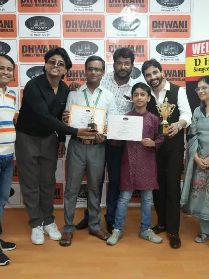 A group of teachers and family members celebrate a student's multiple awards.