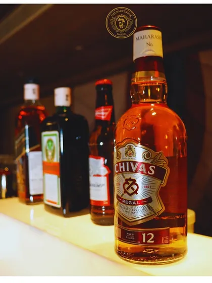 Another view of our well-stocked bar, showcasing a range of premium whiskies and beers. A great party starts with a great selection.