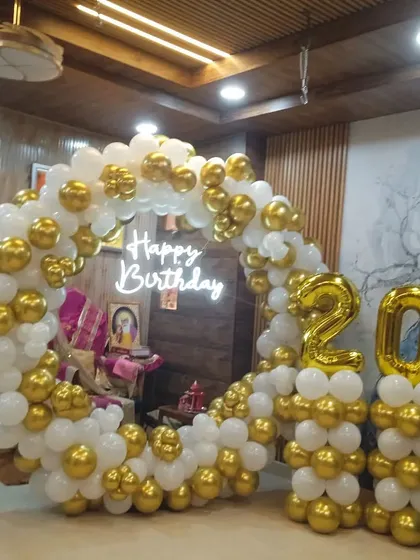 Another view of the elegant white and gold 20th birthday setup, showing how it fits perfectly within a home environment.