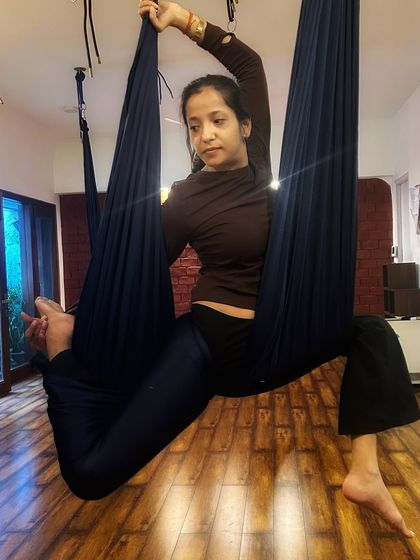 A seated aerial pose that helps open the hips while being fully supported by the hammock. It's both relaxing and effective.