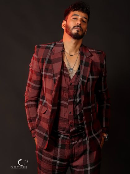 A full-length view of the three-piece suit. The relaxed stance and hands in pockets give off an air of effortless cool.